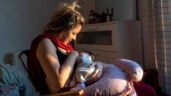 Pregnancy: woman breastfeeding her baby 2079035231