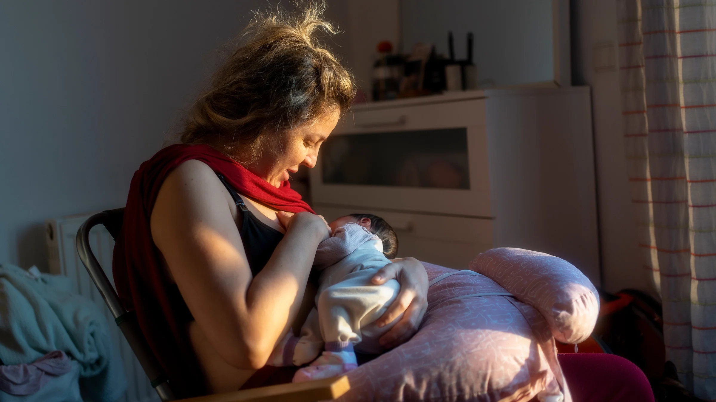A woman breastfeeding her baby.