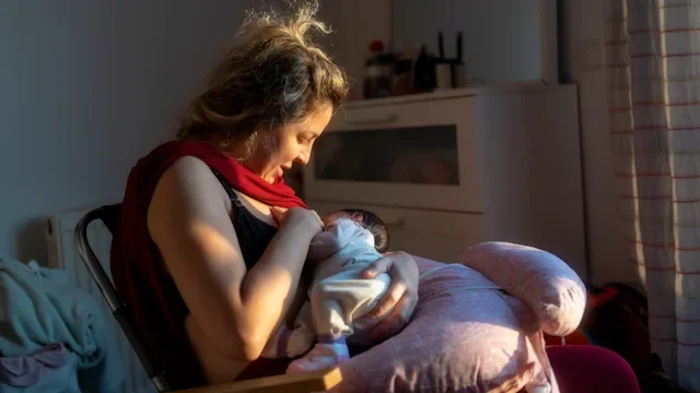 Pregnancy: woman breastfeeding her baby 2079035231
