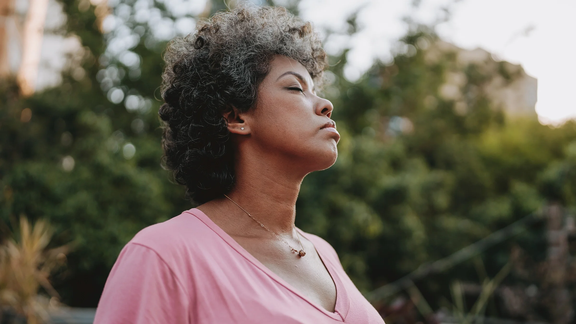 A woman takes a deep breath.