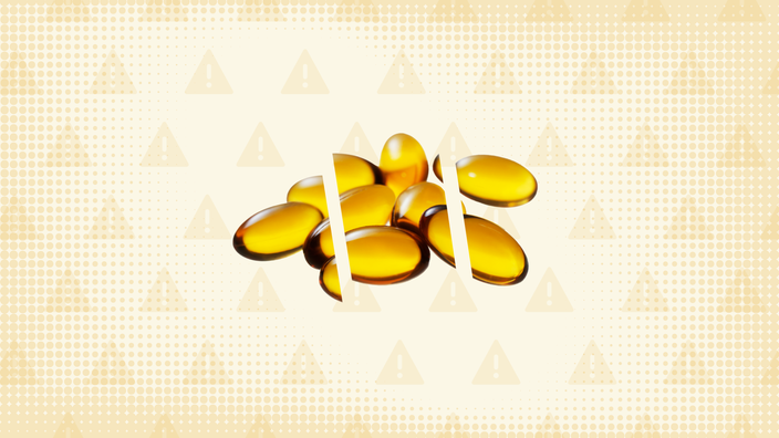 Light-yellow background with texture and warning sign pattern. In the center is a pile of yellow soft gel pills cut into thirds.