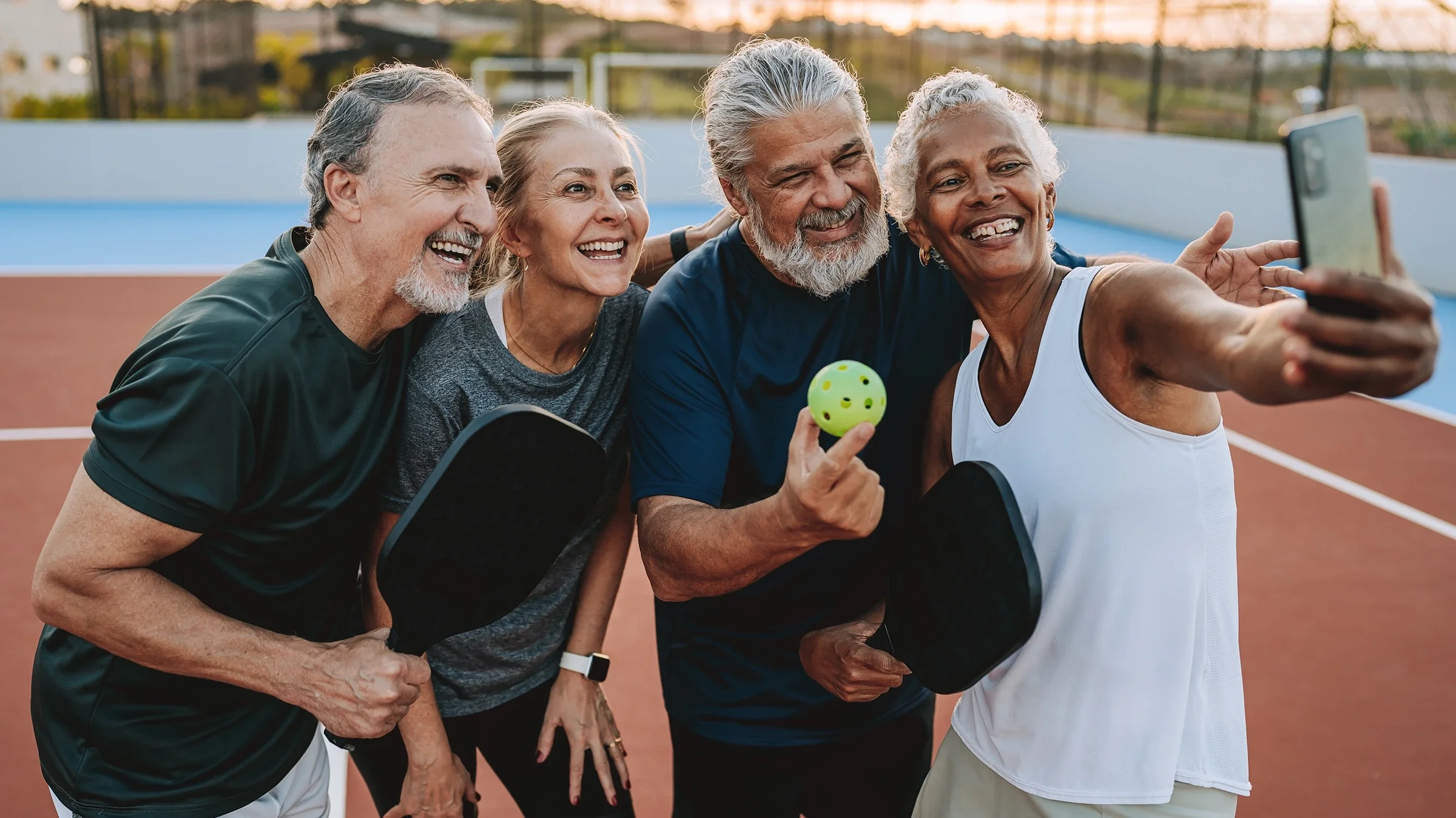 A group of friends play pickleball.