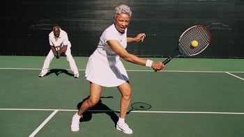 Medicare: senior couple paying doubles tennis dv1271016