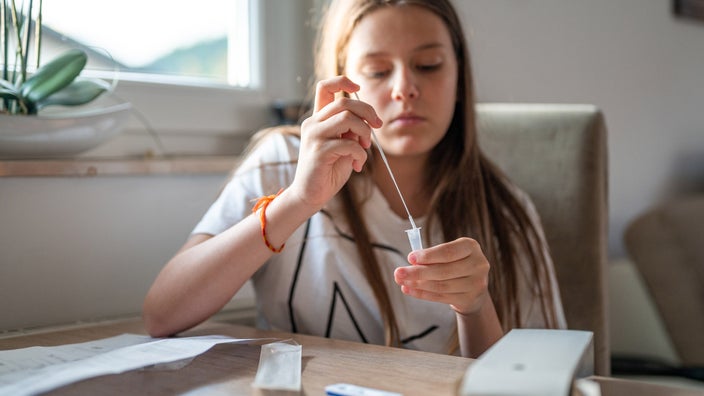 Sick person doing at-home COVID-19 test.