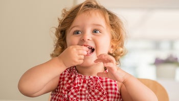 toddler eating vitamins-1042792406