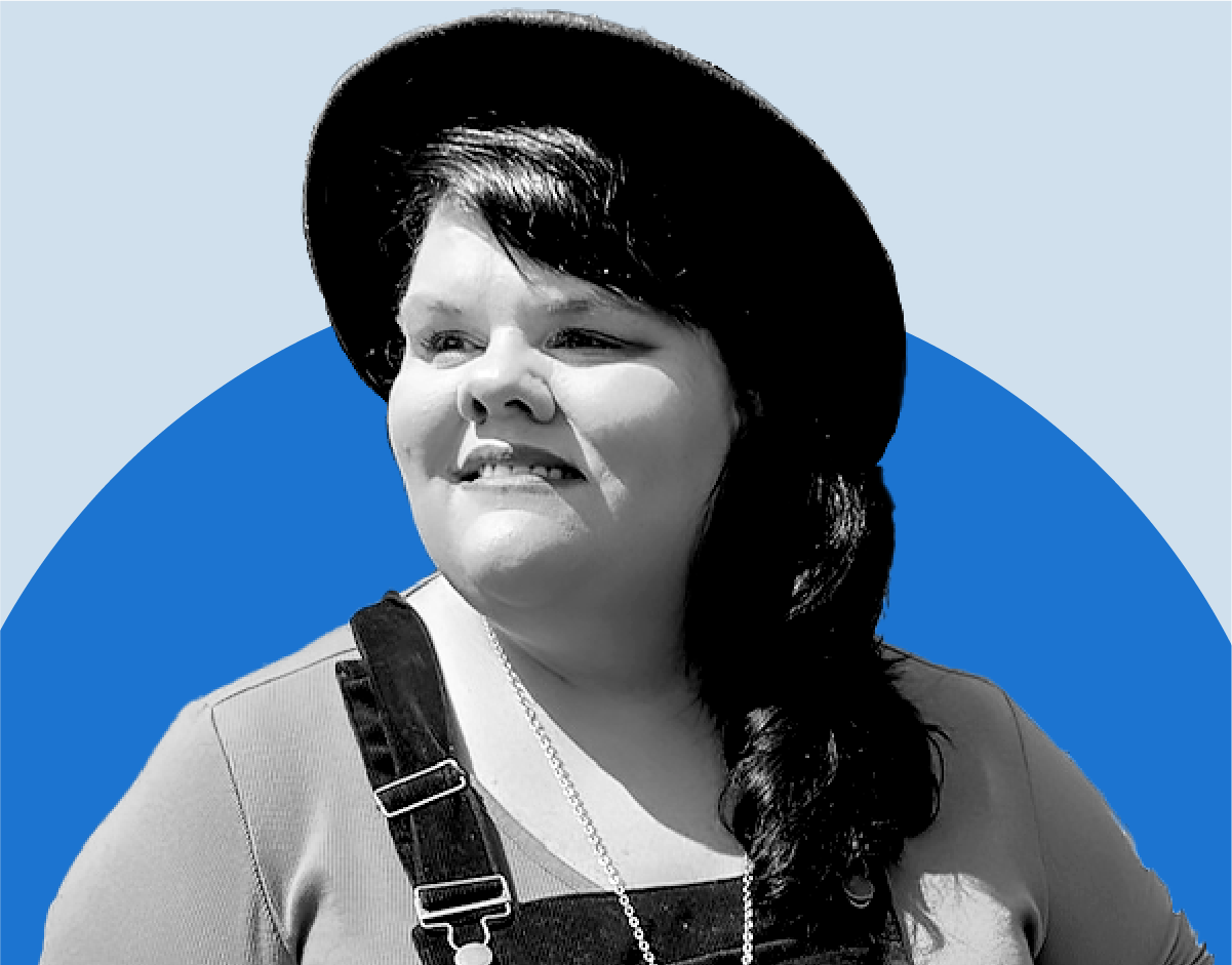 Headshot of Liz Davis wearing a wide-brimmed hat, outdoors.