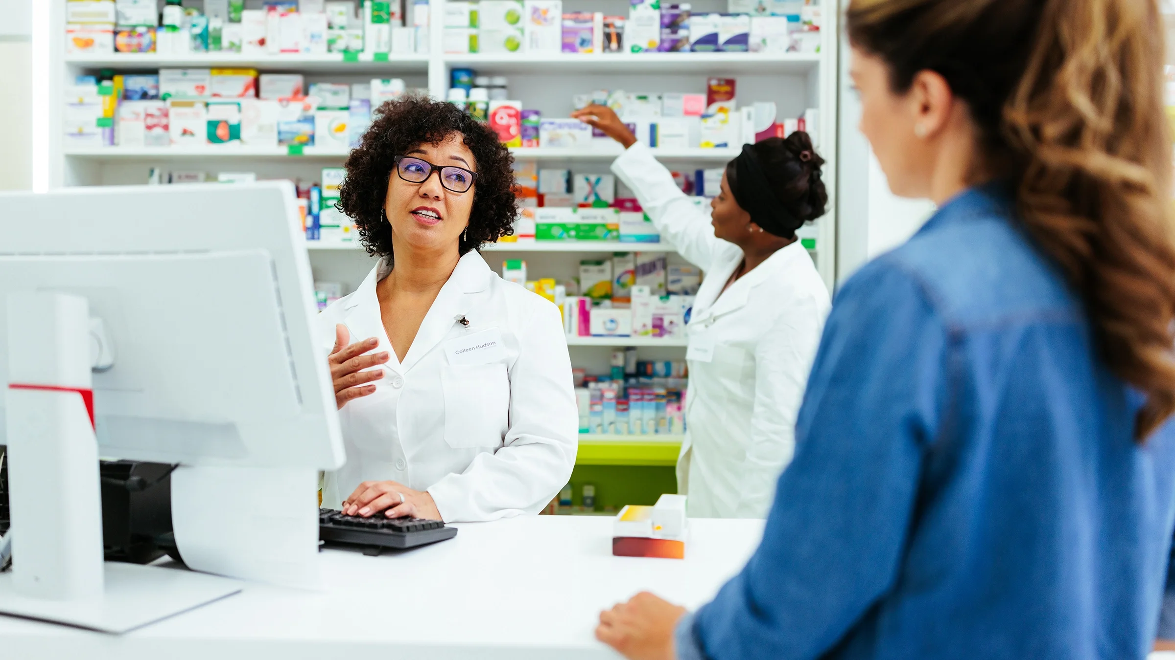 A pharmacist speaks with a customer.