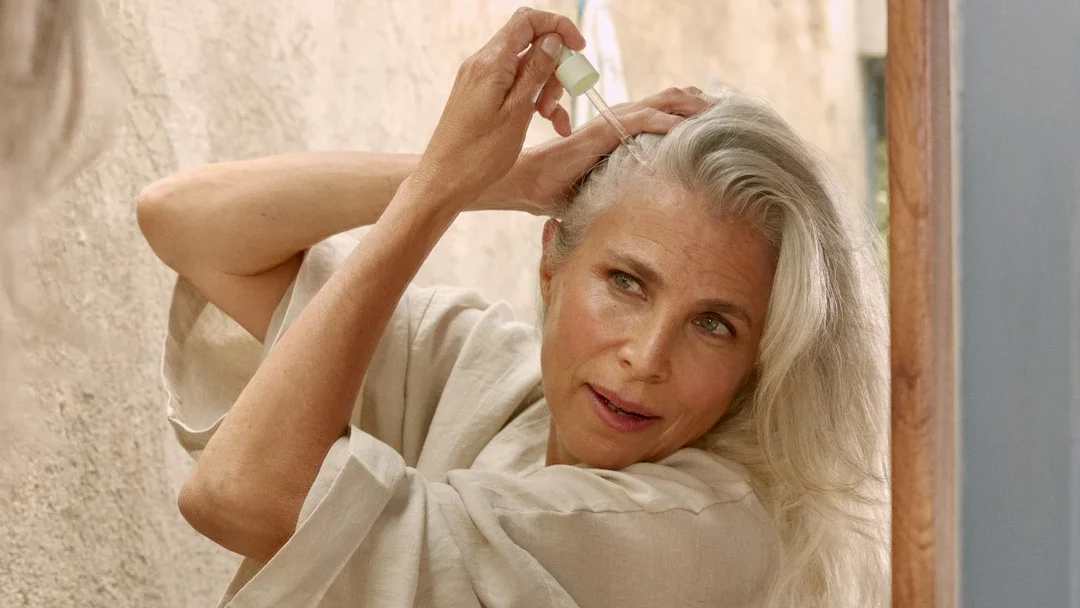 Senior woman applying hair serum
Courtesy of HERS
