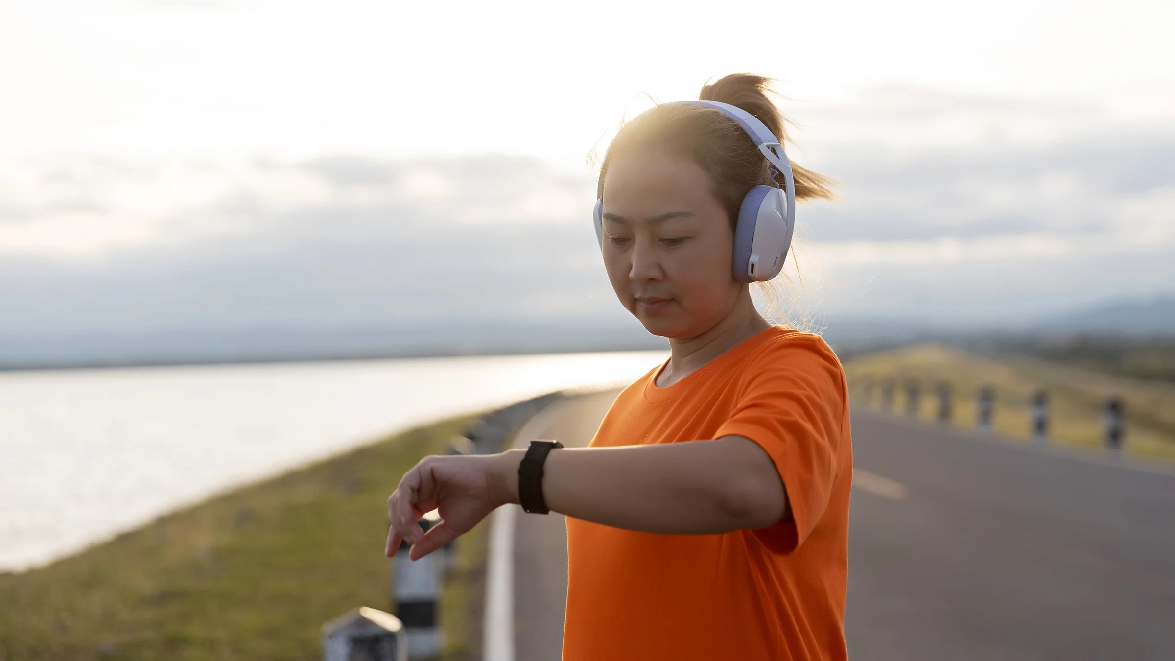 A woman looks at her smartwatch after a workout.