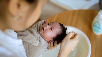 children's health: closeup bathing newborn baby 1325263518