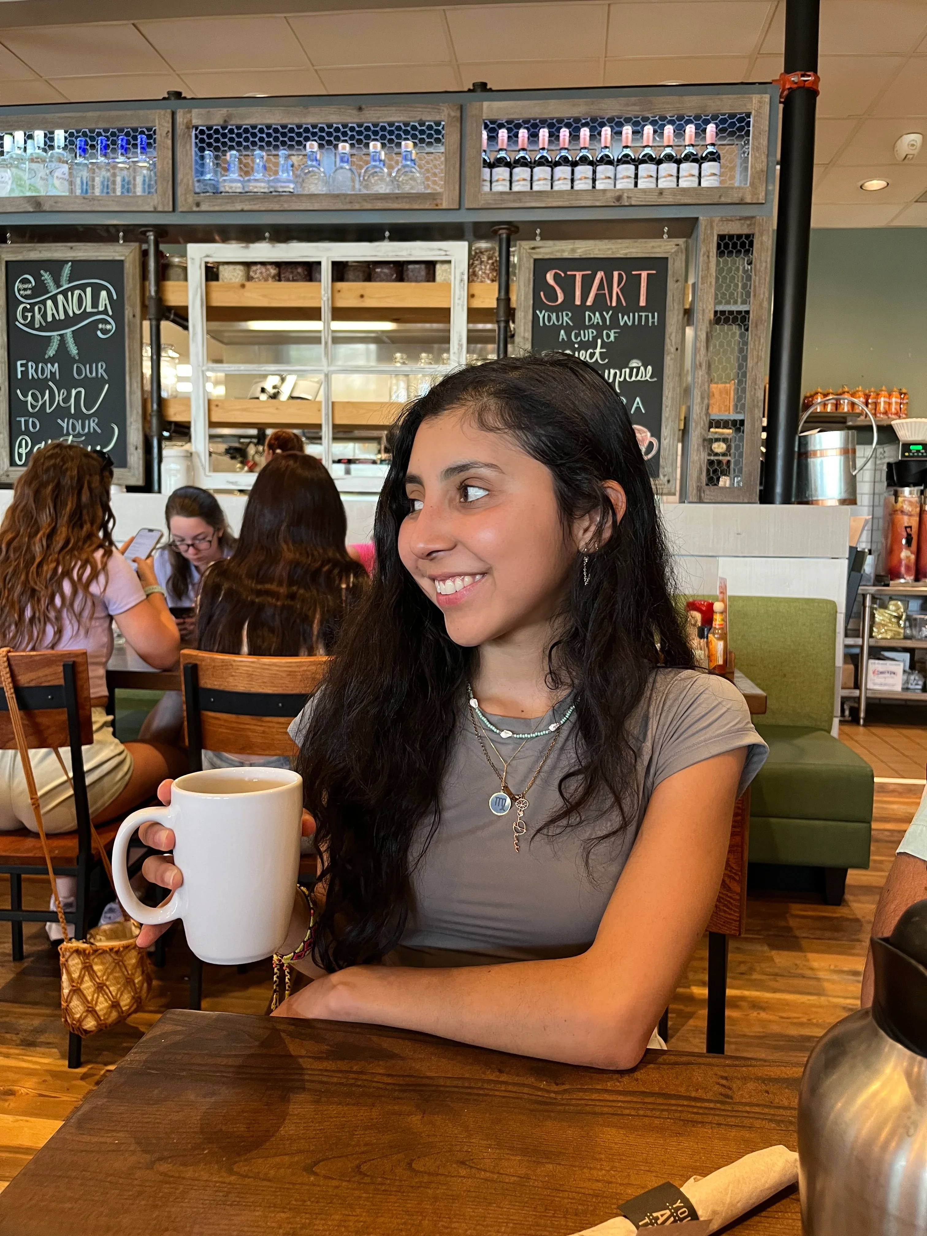 Dani Fernández is pictured sitting in a coffee shop.