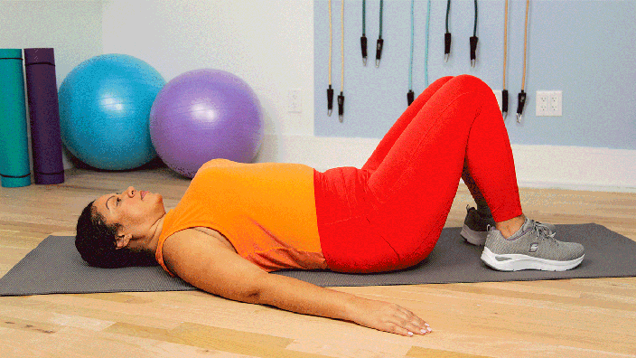 Person demonstrating pelvic tilt movement by tucking their hips.