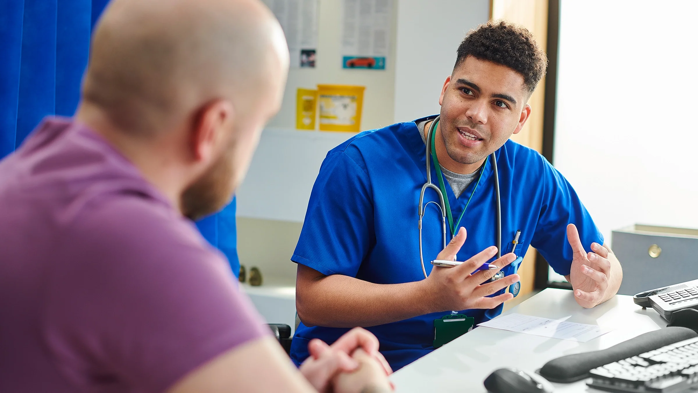 A medical professional is talking to a patient about their treatment plan. 