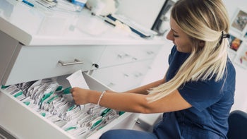 Patient advocacy: nurse retrieving patient files 1035676744