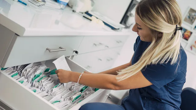 Patient advocacy: nurse retrieving patient files 1035676744