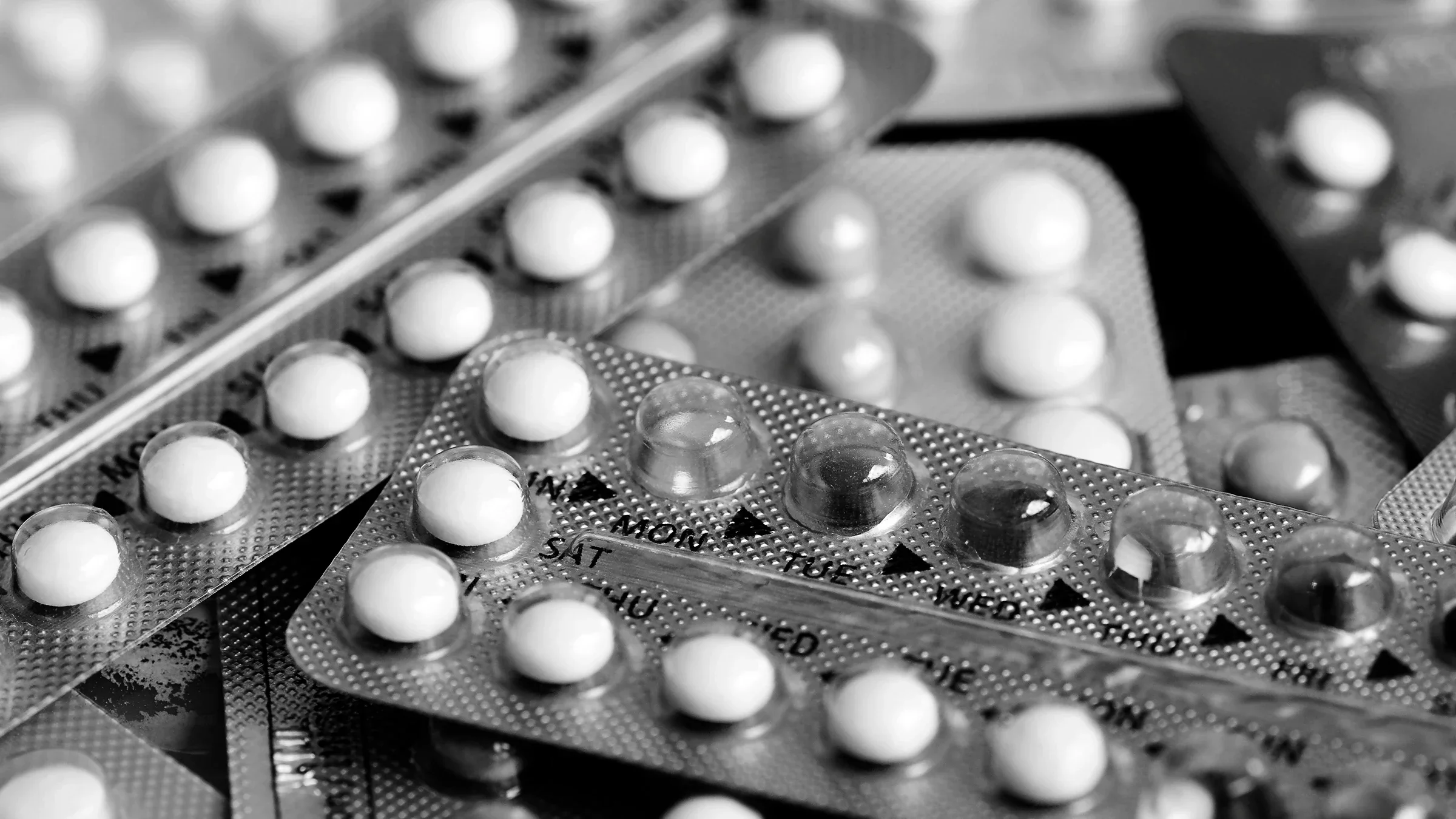 Black and white close-up of many birth control packs.
areeya_ann/iStock via Getty Images
