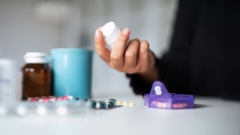 jardiance: closeup holding white prescription bottle 1740055849