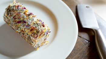 Health: diet-nutrition: goat cheese log with edible flowers on plate-1313951092