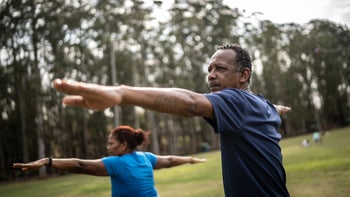 Black health: man and woman practicing yoga 1415828699