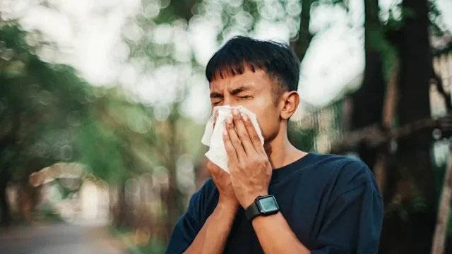 Allergies: man blowing his nose 2264155724