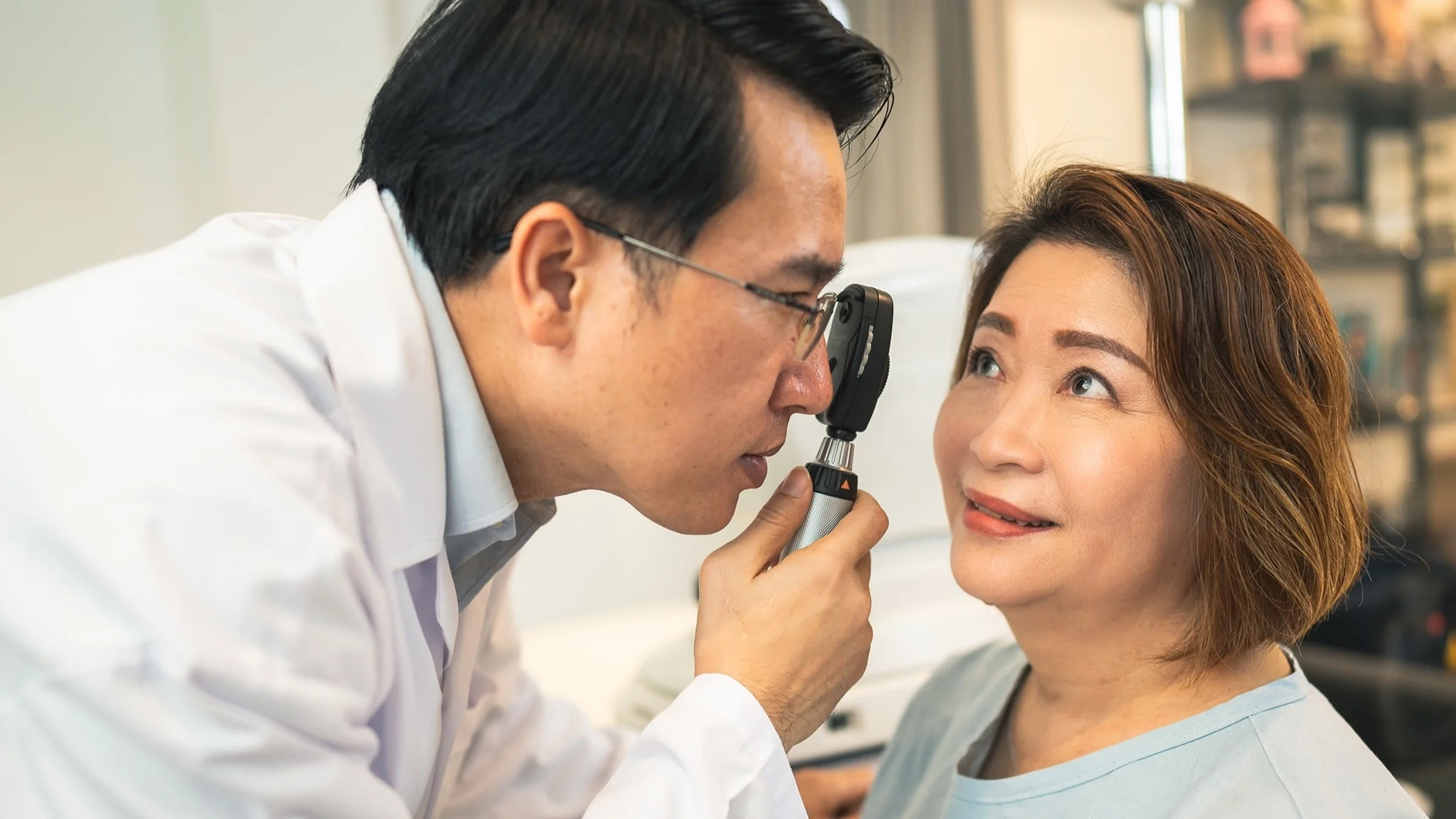 Middle aged woman getting her eyes checked by an optometrist.