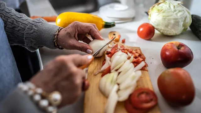 Gut health: closeup cutting onions 1475584098