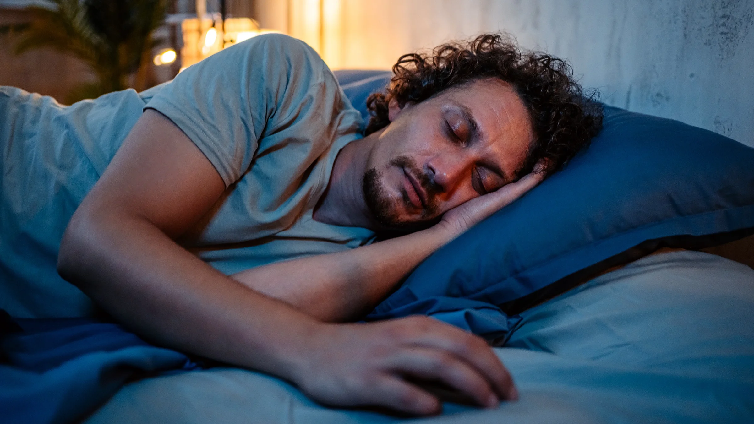 Man sleeping in bed at night.