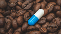 A pill among a pile of coffee beans.
Андрей Клеменков/iStock via Getty Images 