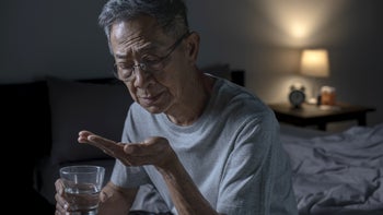 Health: Trazodone: senior man taking pill before bed 1466291424