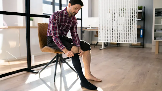 Musculoskeletal: man putting on compression socks 1372833378