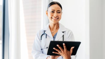 Pharmacists: Telehealth: portrait of doctor holding a tablet 1425469911