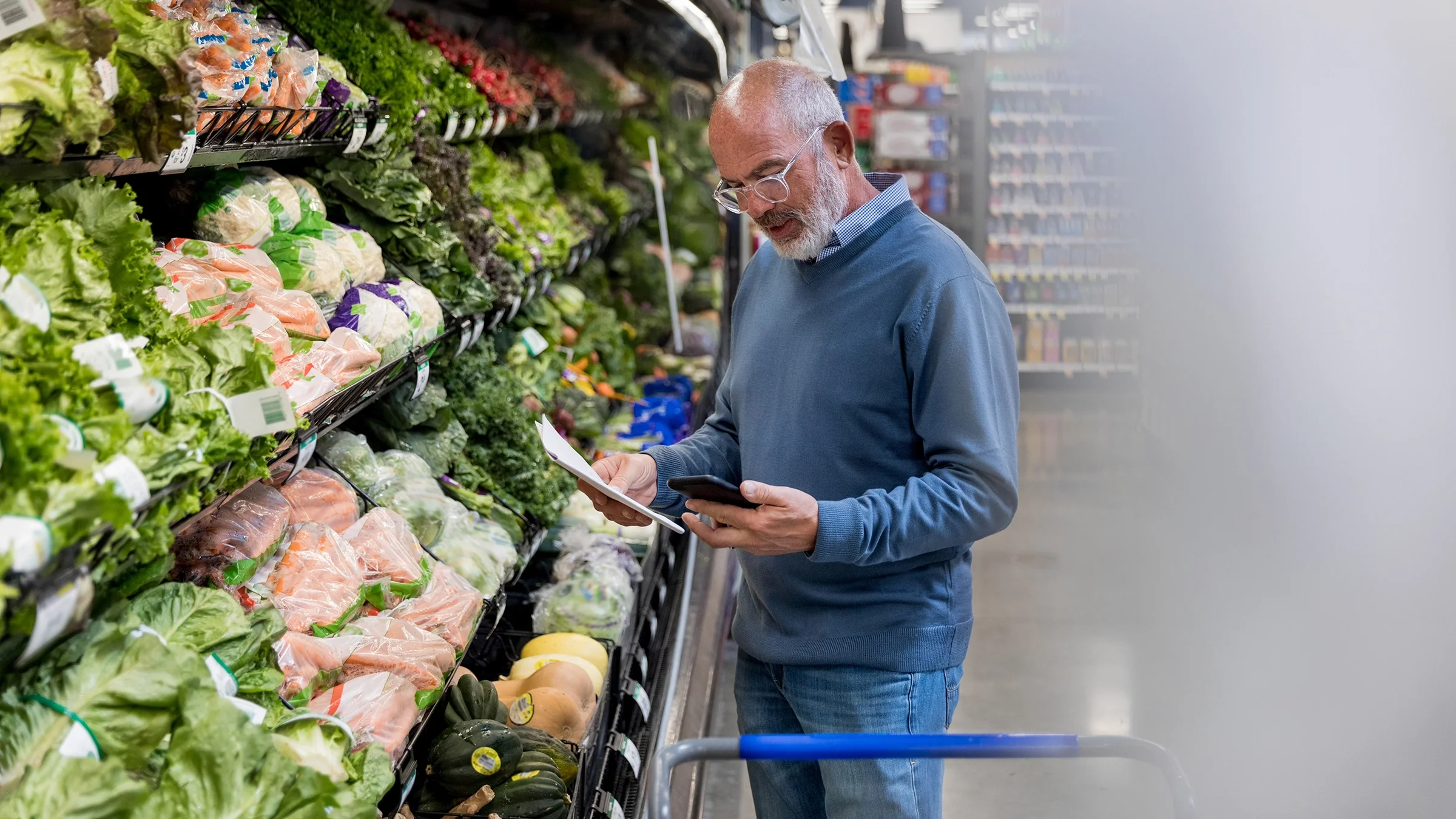 Man looks at grocery list on his phone.