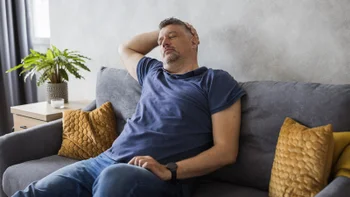 Wegovy: man napping on a couch 1500403341