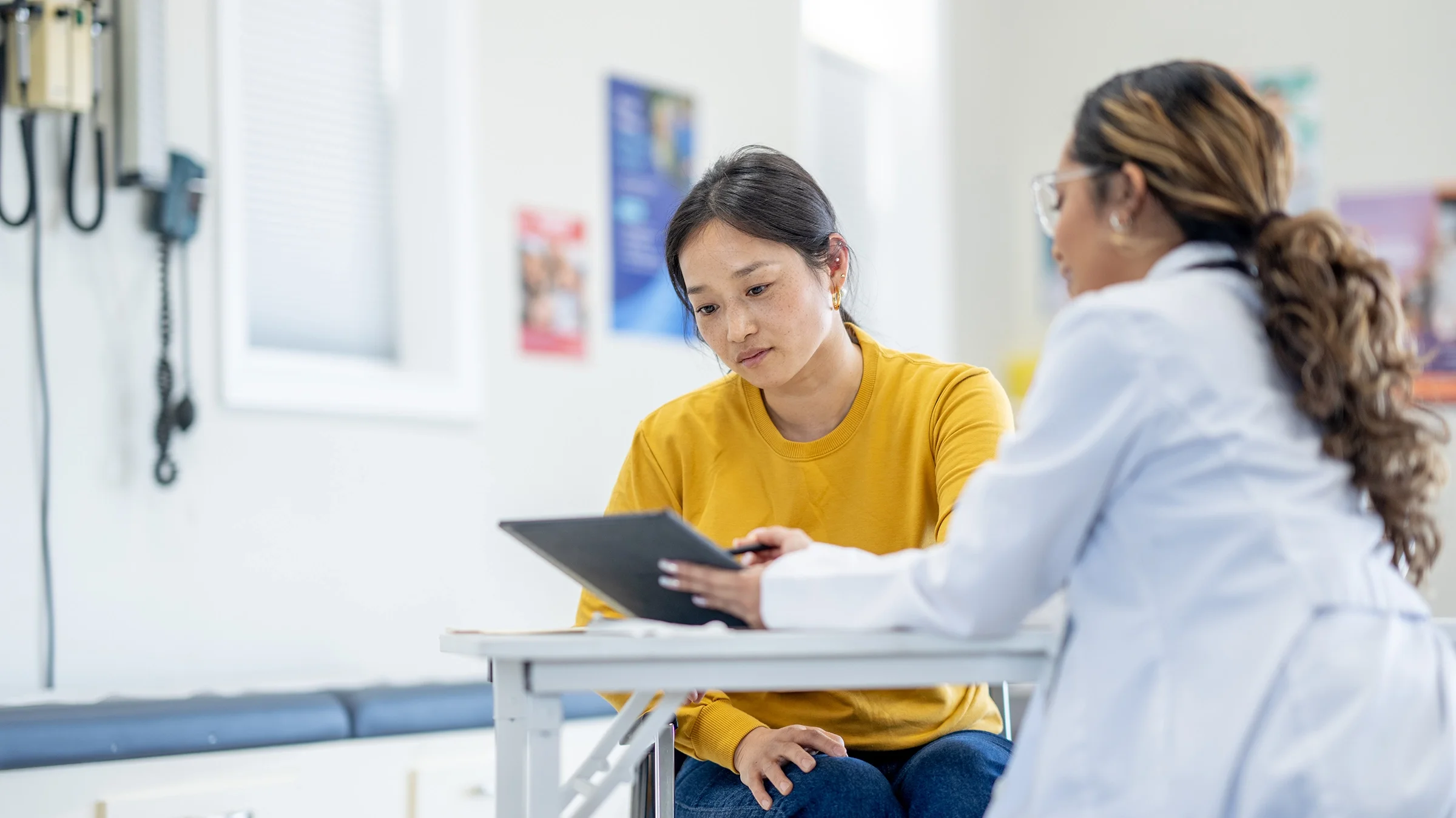 A woman receives test results during a medical appointment.