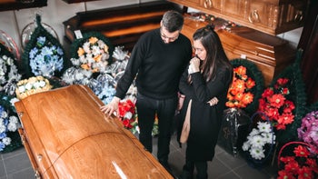 Health: Health Insurance: paying respects at funeral-1308172184