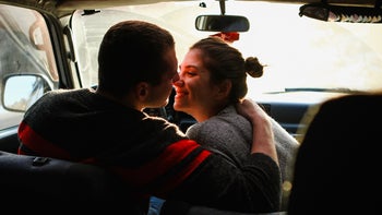 STDs: kissing: couple about to kiss in car 506621102