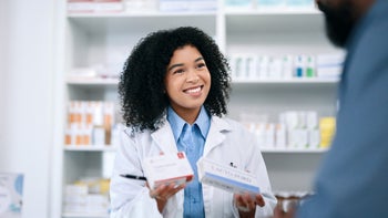 Savings: pharmacist assisting customer with medication 1432720071