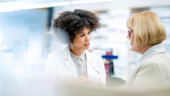 Senior Health: senior woman speaking to a pharmacist 1132093457