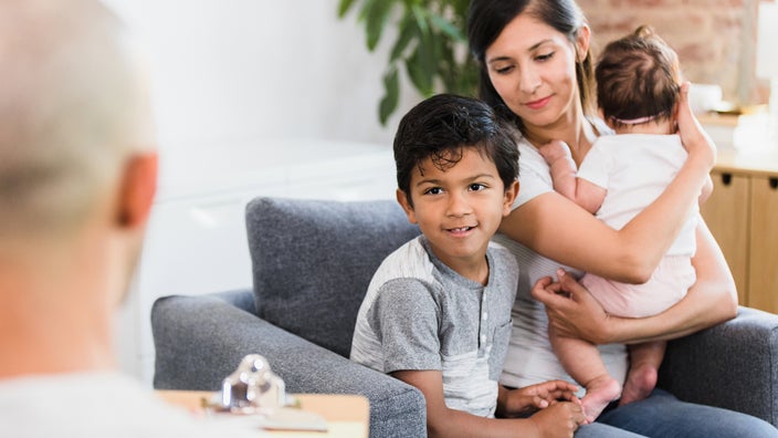 A mother and her son attend a therapy session. 