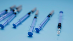 Blue syringes on a light blue background.
Adam Smigielski/iStock via Getty Images