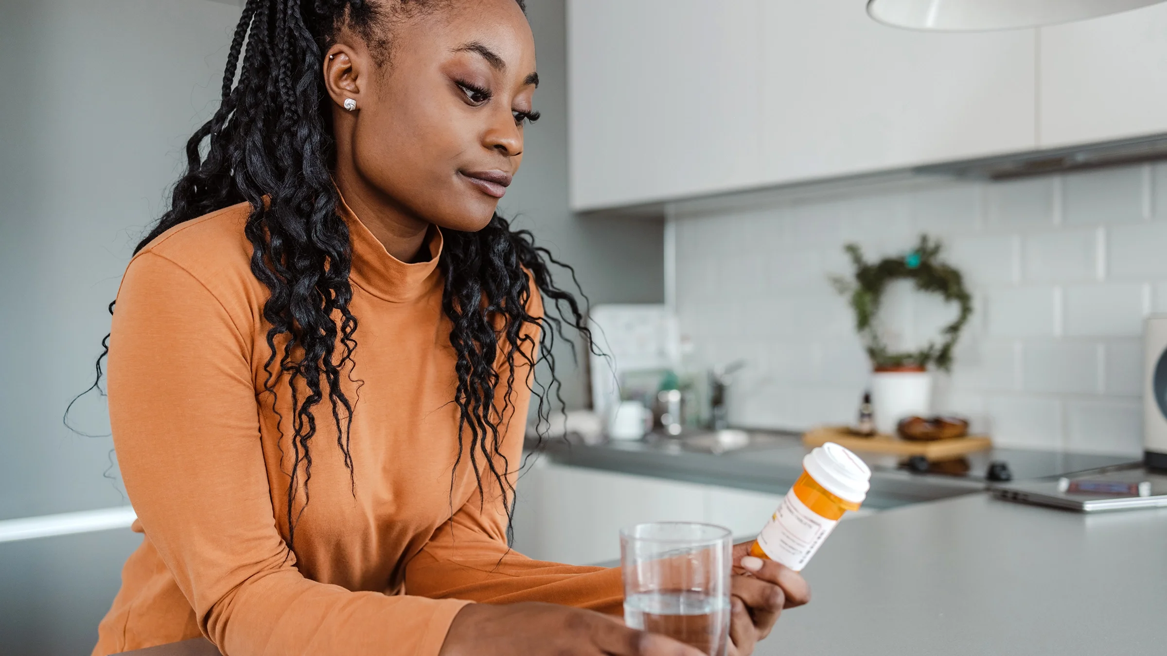 A woman reads the instructions on her prescription label.