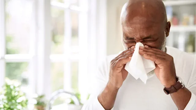 antihistamines: allergy: cold: flu: man sneezing into tissue-949412934
