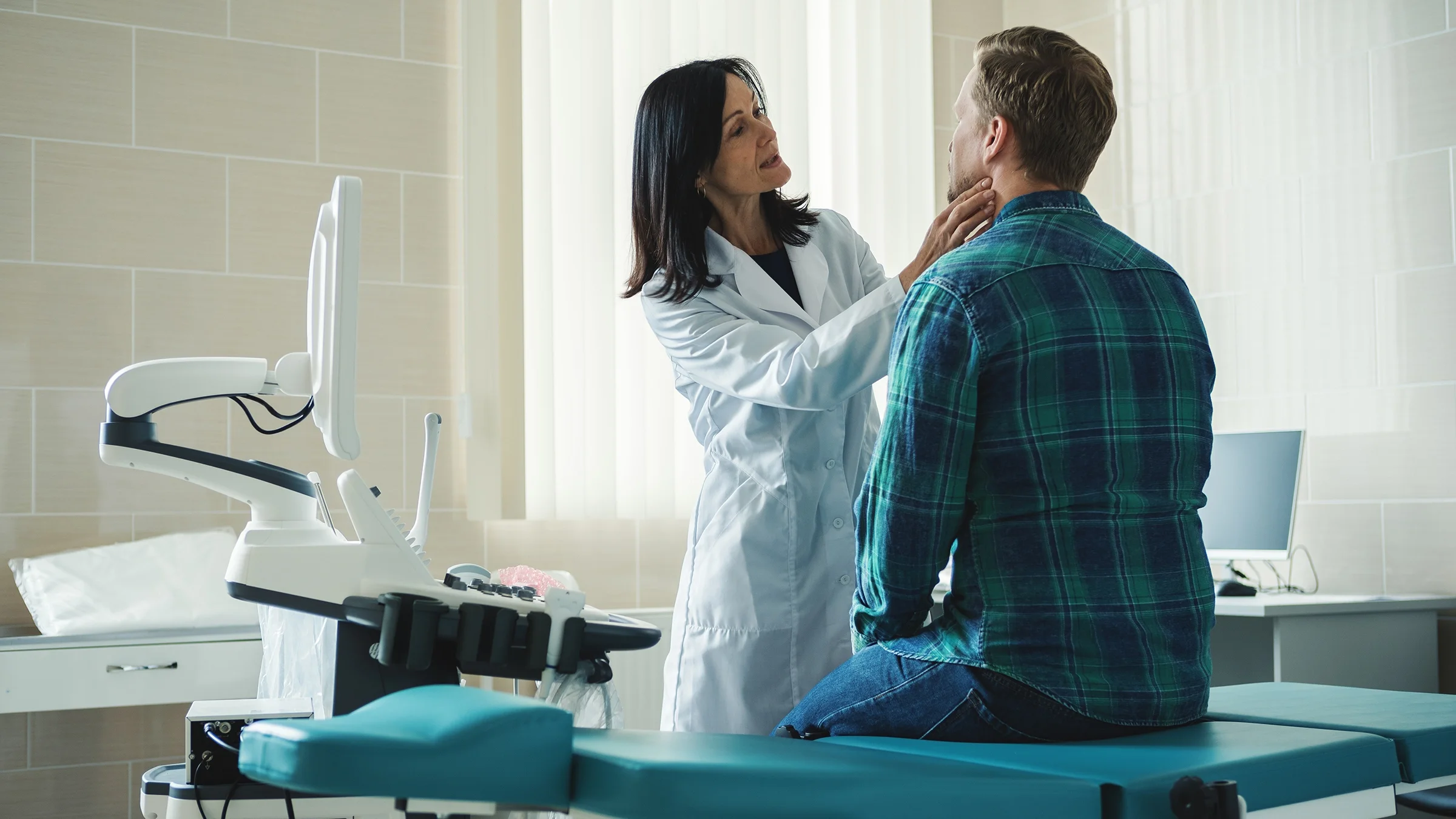 Doctor checking lymph nodes of patient