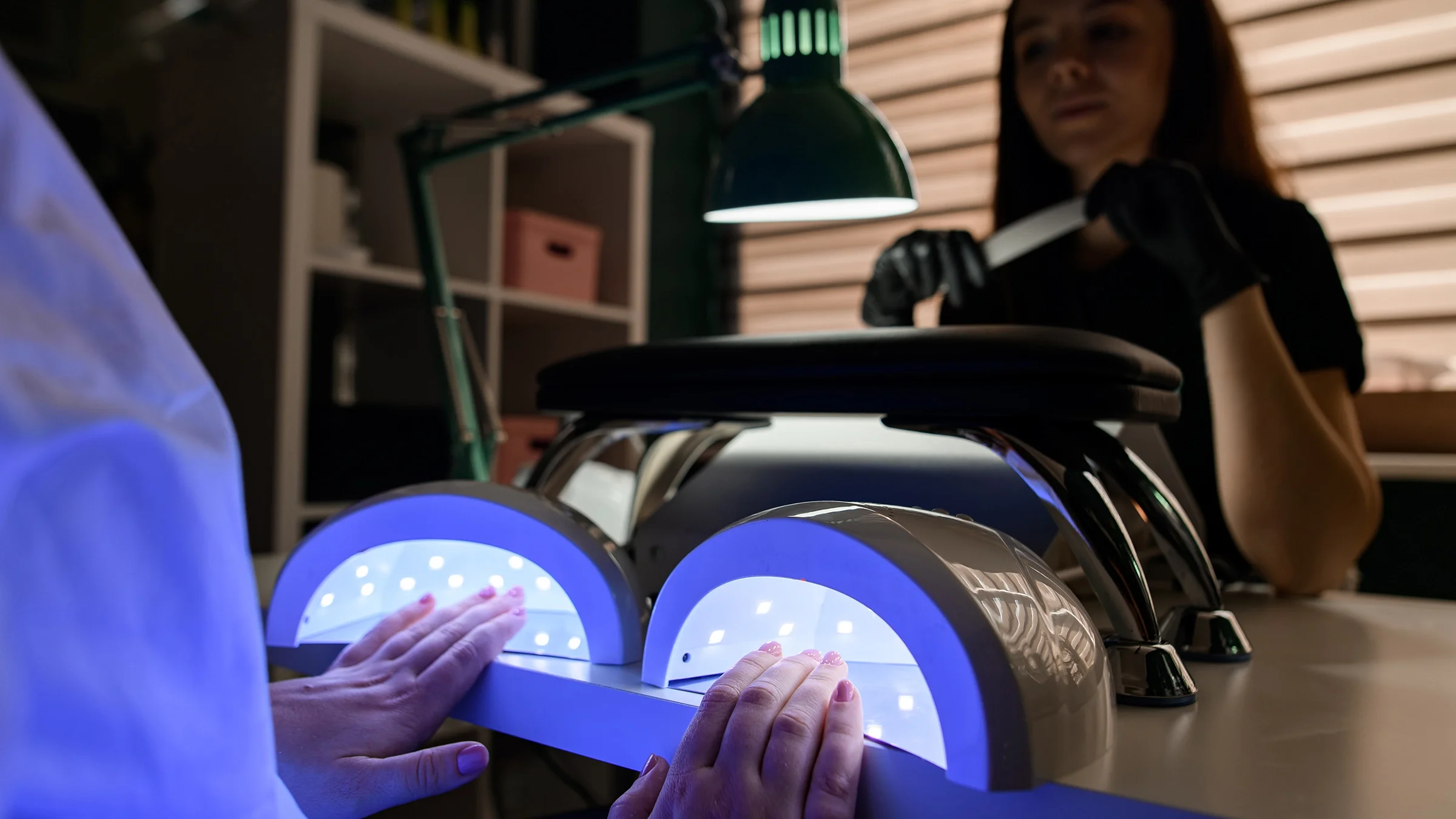 Close-up woman getting gel manicure.