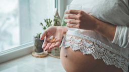 A pregnant person holding pills and a glass of water.
Anastasiia Stiahailo/iStock via Getty Images Plus 