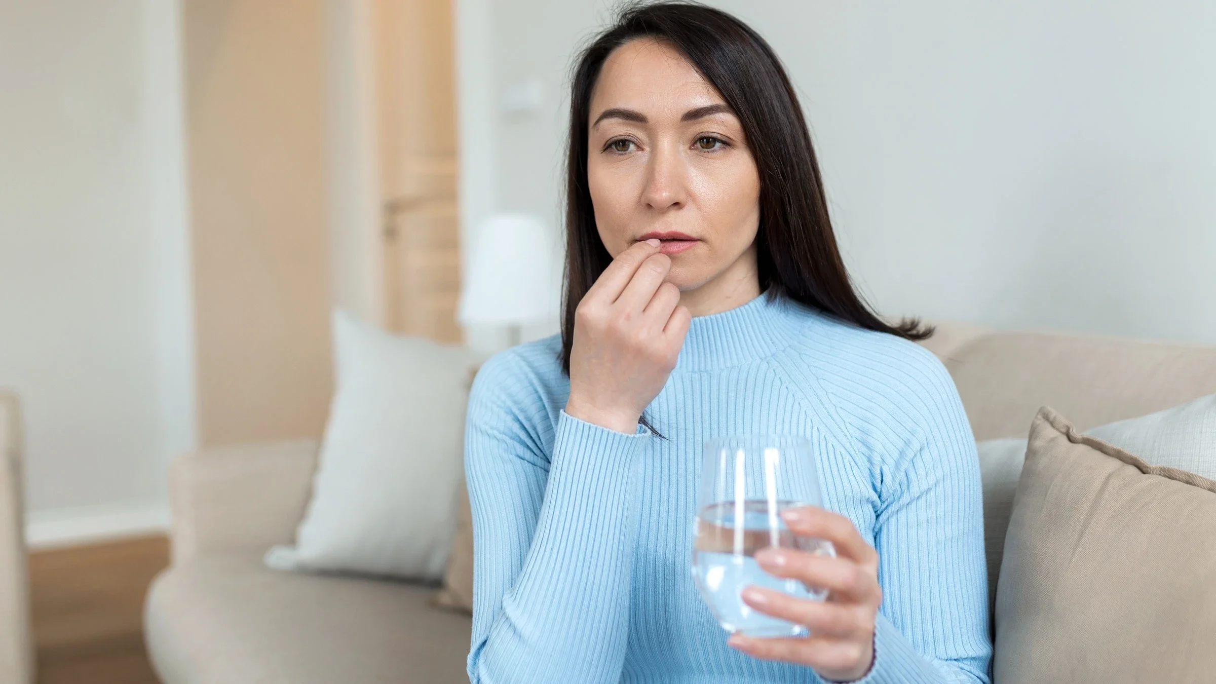 Taking pill with water.