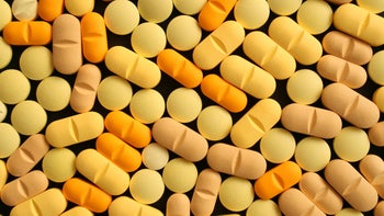 Pharmacy: yellow pills on black background 172514311