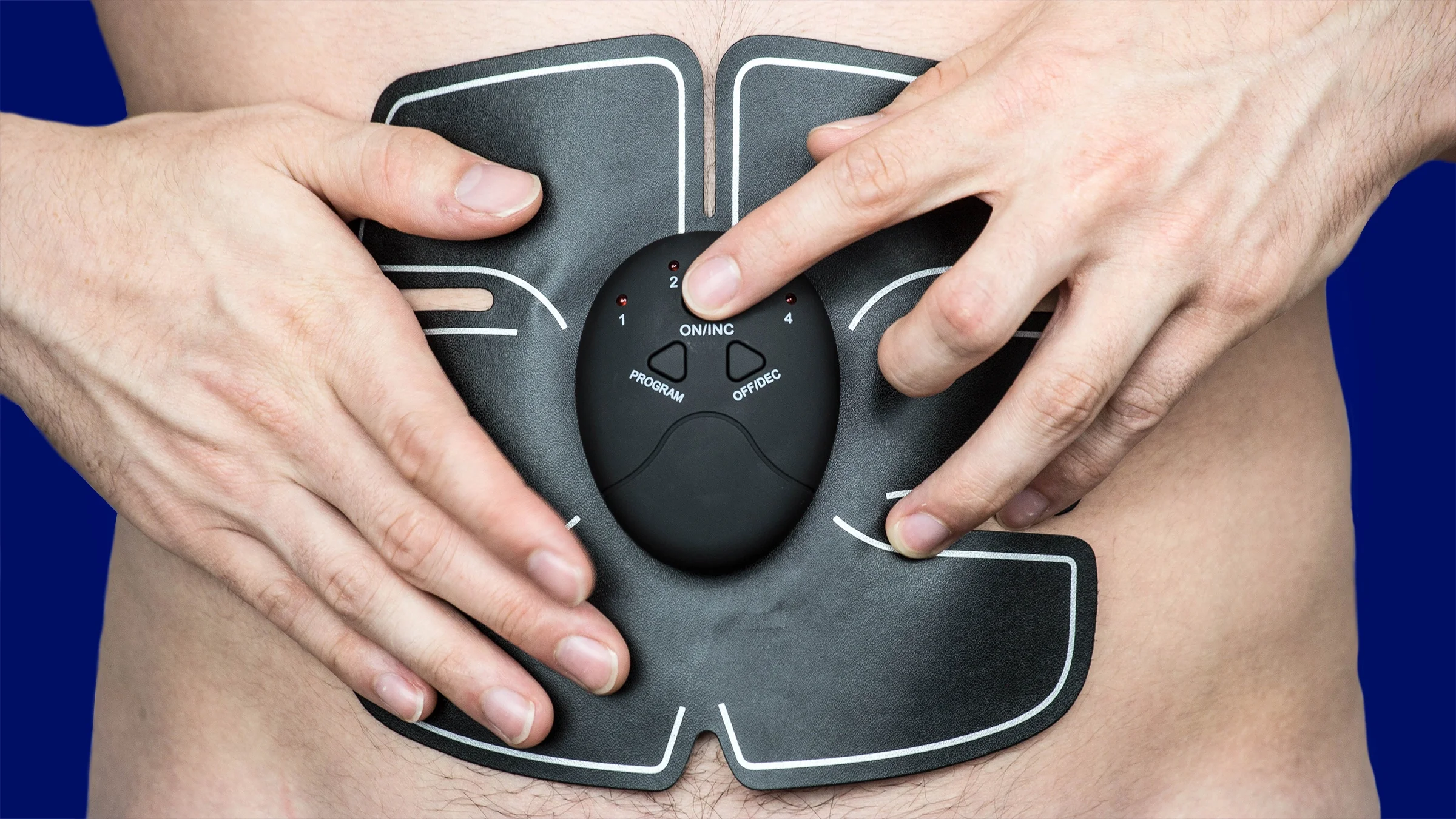Close-up of a man wearing an ab muscle stimulator.