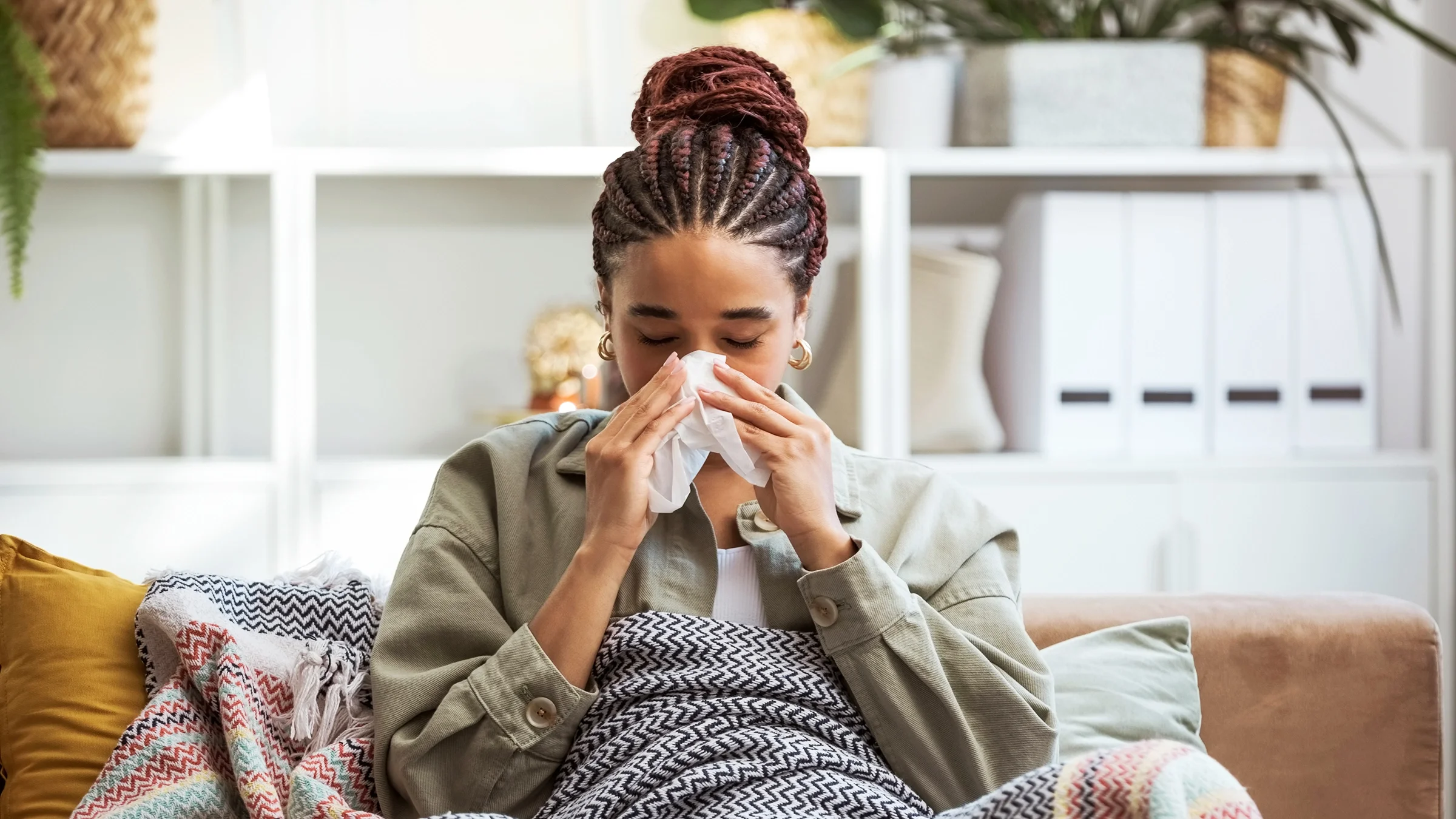 A woman blows her nose.