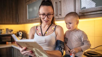 Heart: Cardiac monitoring insurance: parent with holter monitor reading book 1471663190